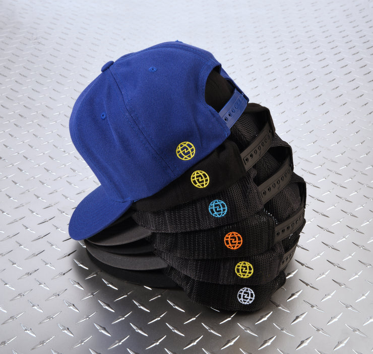 Stack of trucker caps showing a small embroidered logo on the back